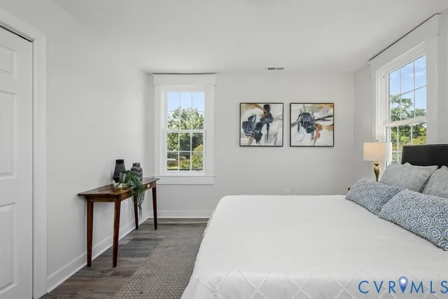 a bedroom with a bed and wooden floor