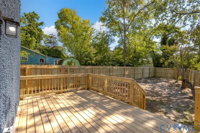 a view of a balcony with wooden floor and fence