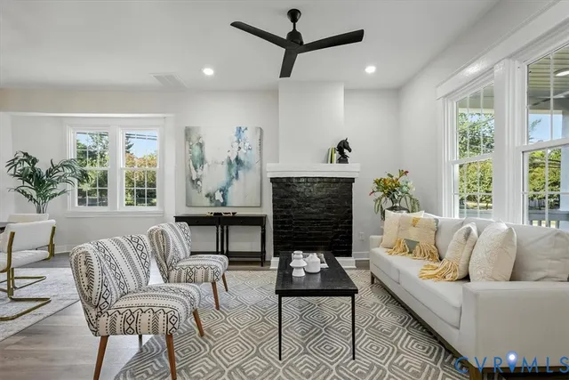 a living room with furniture a fireplace and a table