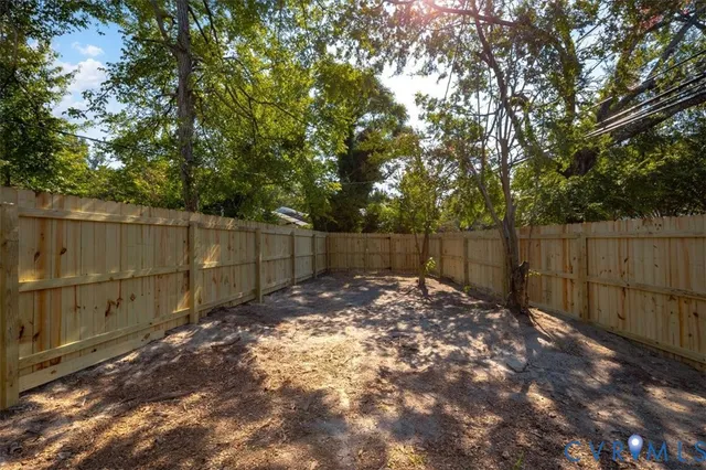 a backyard of a house with a tree