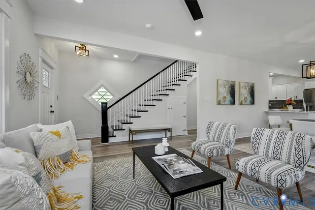 a living room with furniture and wooden floor