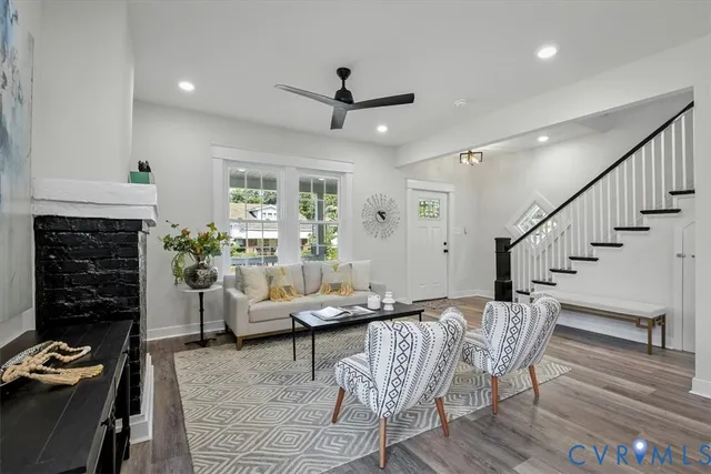a living room with furniture and wooden floor