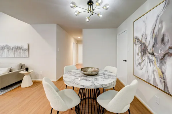 a dining room with furniture and wooden floor