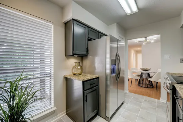 a kitchen with stainless steel appliances a refrigerator and a sink