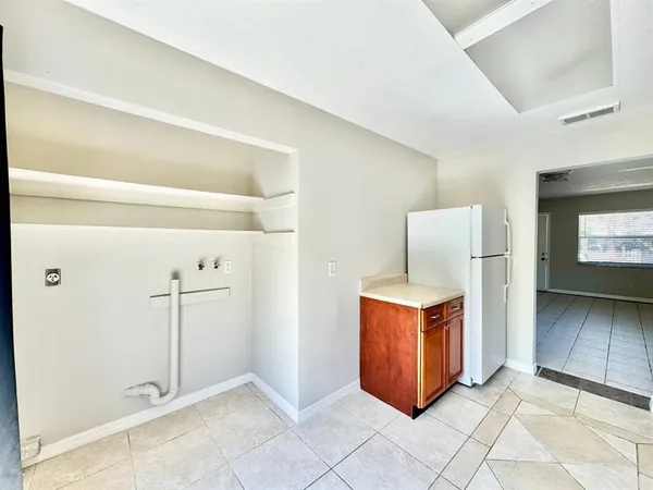 a view of a room with an empty space and a window