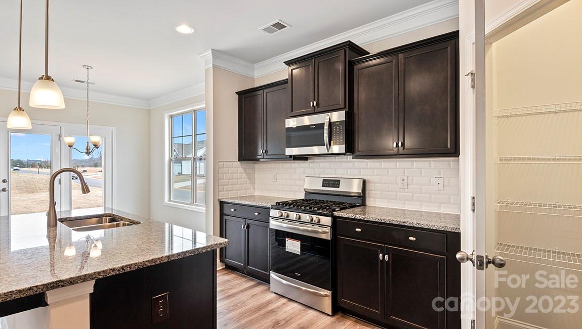 245 Fox Cove Road Hendersonville, NC 28792 - Photo 11 of 33 a kitchen with kitchen island granite countertop stainless steel appliances and a sink