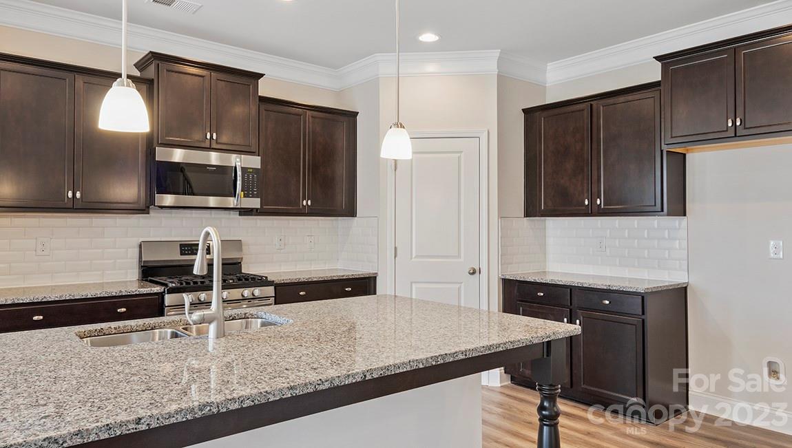245 Fox Cove Road Hendersonville, NC 28792 - Photo 13 of 33 a kitchen with stainless steel appliances granite countertop a sink a stove and a refrigerator