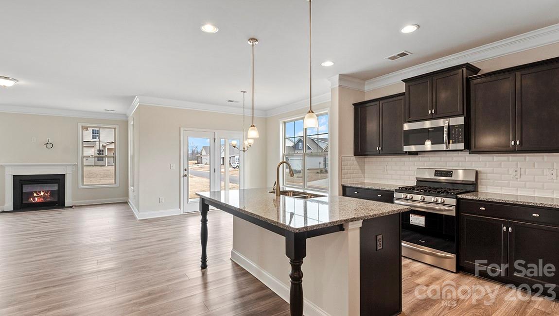 245 Fox Cove Road Hendersonville, NC 28792 - Photo 14 of 33 a kitchen with granite countertop a stove refrigerator and microwave