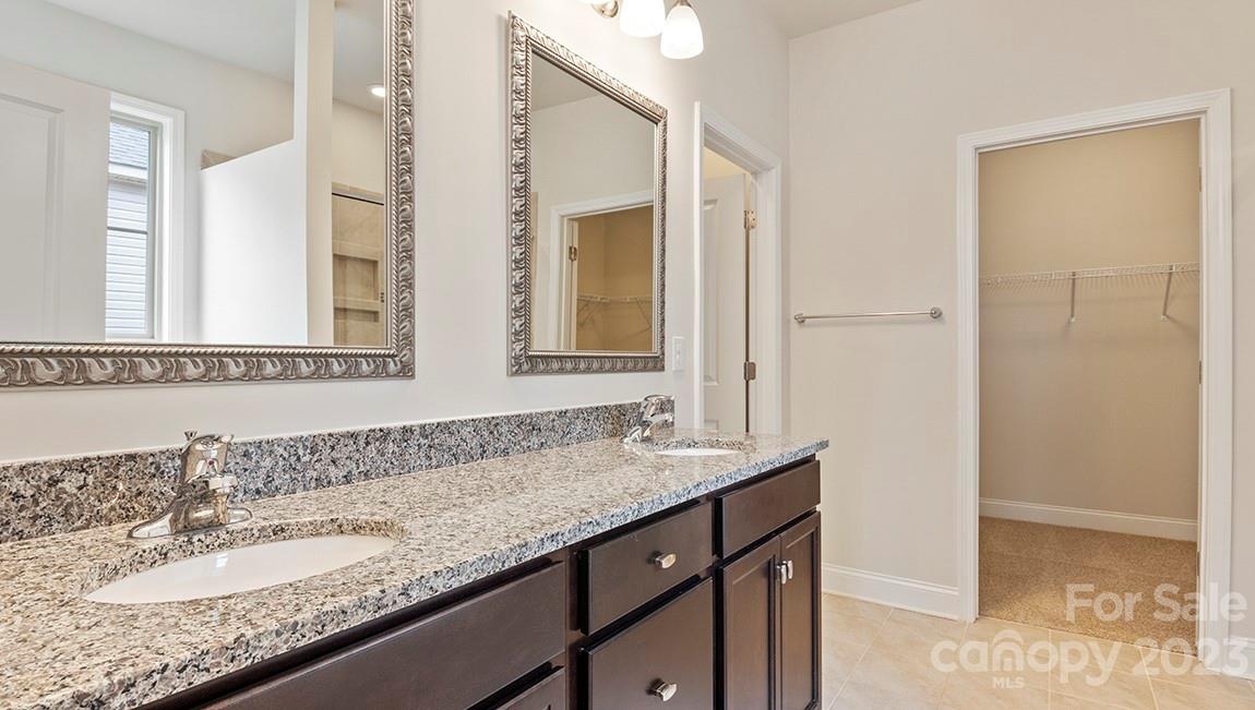 245 Fox Cove Road Hendersonville, NC 28792 - Photo 18 of 33 a bathroom with a granite countertop sink and a mirror