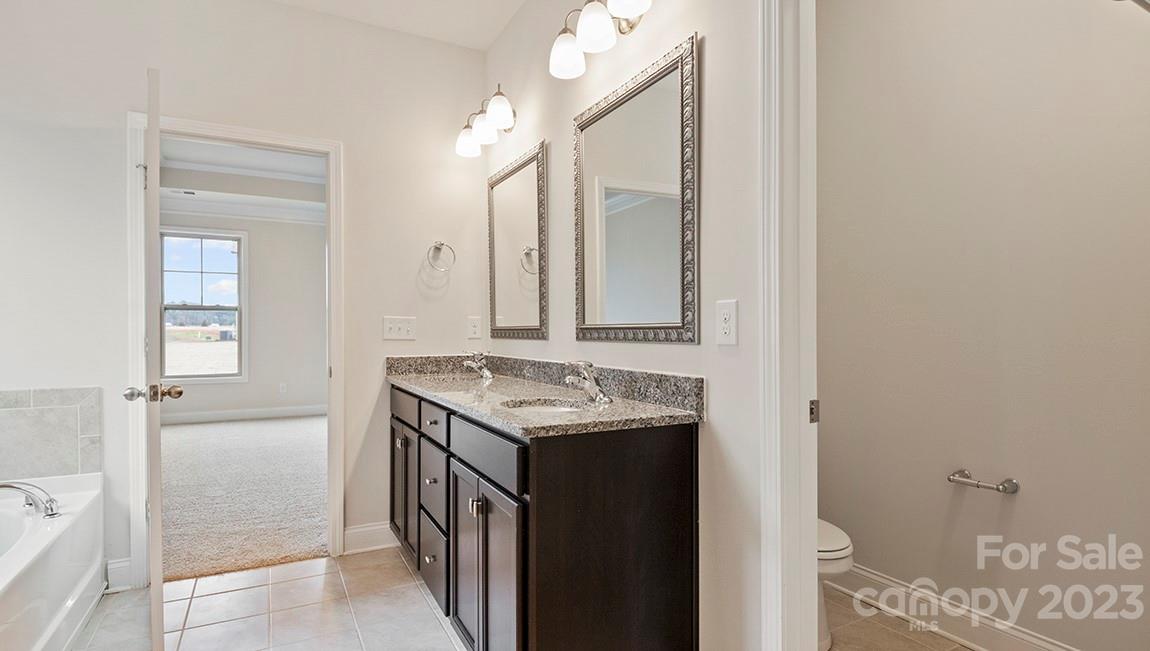 245 Fox Cove Road Hendersonville, NC 28792 - Photo 20 of 33 a bathroom with a granite countertop sink and a mirror