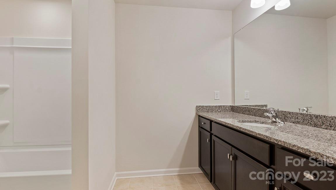 245 Fox Cove Road Hendersonville, NC 28792 - Photo 29 of 33 a bathroom with a granite countertop sink and a mirror