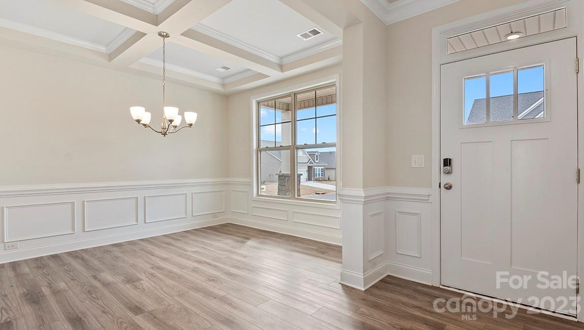 245 Fox Cove Road Hendersonville, NC 28792 - Photo 5 of 33 a view of empty room with wooden floor and fan