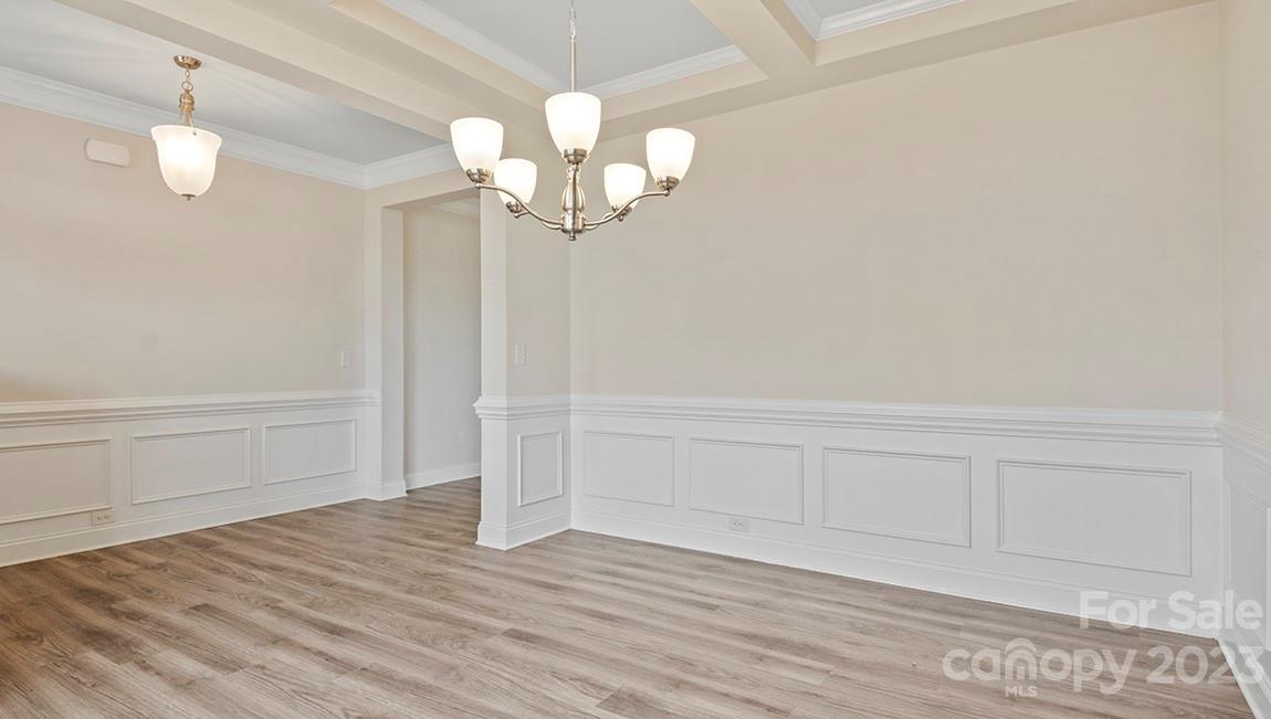 245 Fox Cove Road Hendersonville, NC 28792 - Photo 6 of 33 a view of a chandelier fan and wooden floor