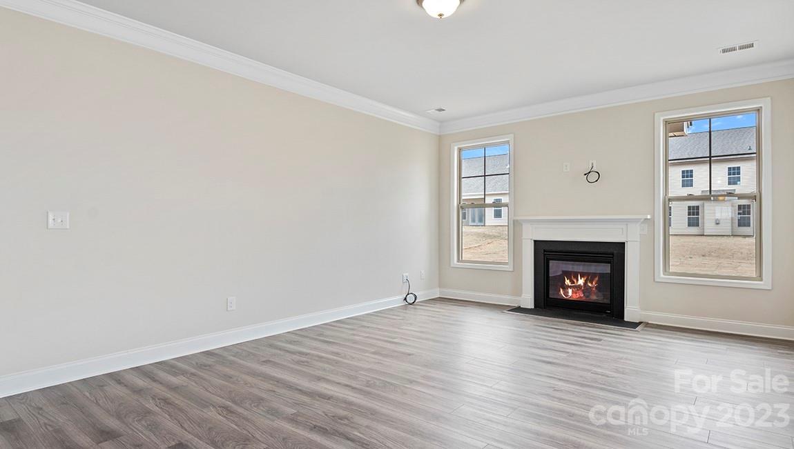245 Fox Cove Road Hendersonville, NC 28792 - Photo 9 of 33 a view of an empty room with wooden floor fireplace and a window