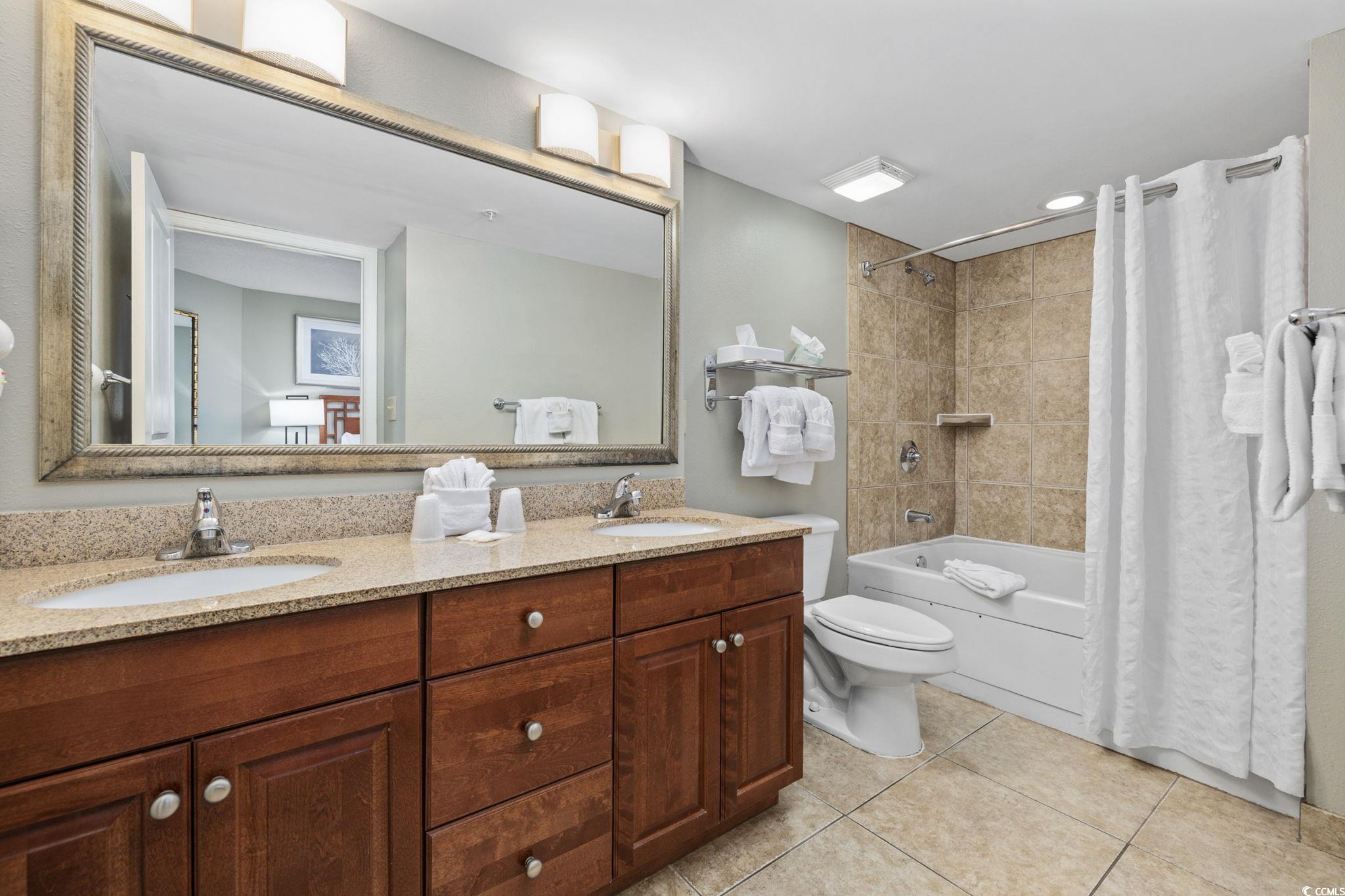 5200 North Ocean Boulevard, Unit 857 Myrtle Beach, SC 29577 - Photo 11 of 40 Bathroom with tile patterned floors, double vanity, and shower / tub combo