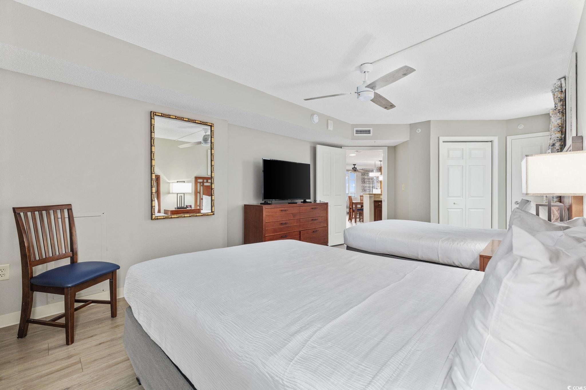 5200 North Ocean Boulevard, Unit 857 Myrtle Beach, SC 29577 - Photo 12 of 40 Bedroom with light wood finished floors and a ceiling fan