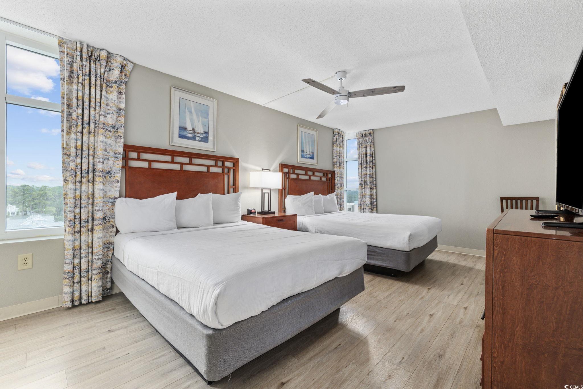 5200 North Ocean Boulevard, Unit 857 Myrtle Beach, SC 29577 - Photo 13 of 40 Bedroom with a textured ceiling, light wood finished floors, and a ceiling fan