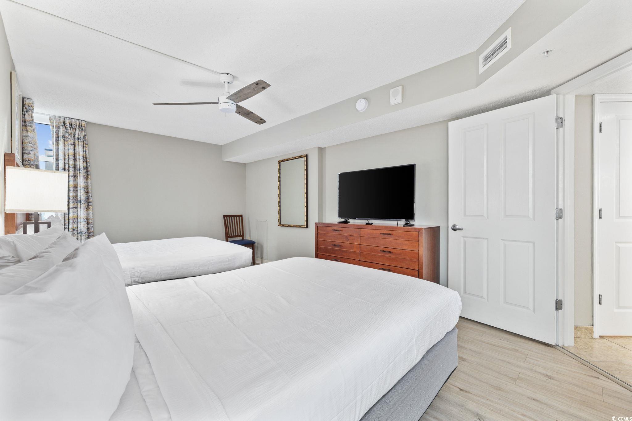 5200 North Ocean Boulevard, Unit 857 Myrtle Beach, SC 29577 - Photo 15 of 40 Bedroom with light wood finished floors and ceiling fan