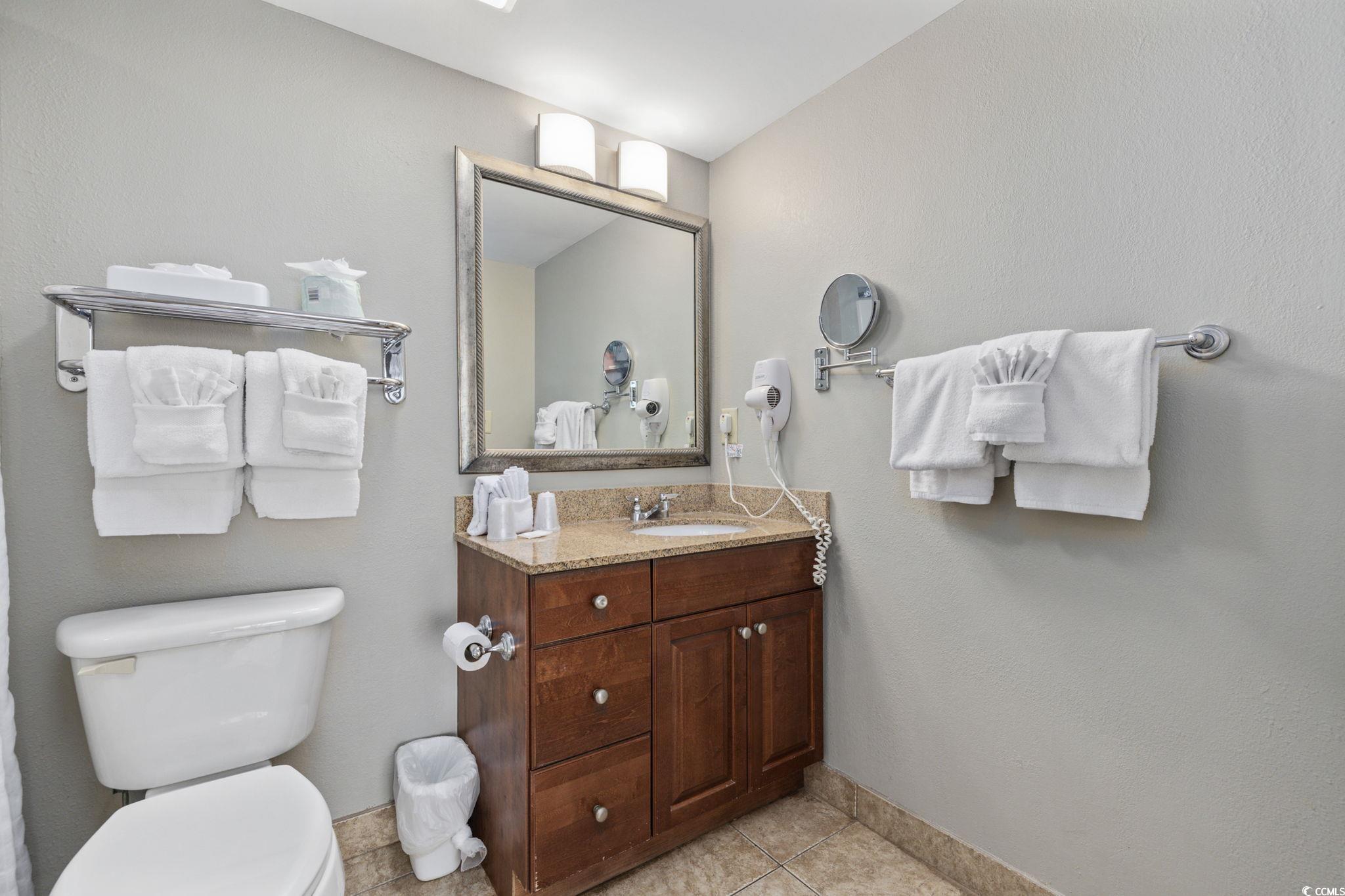 5200 North Ocean Boulevard, Unit 857 Myrtle Beach, SC 29577 - Photo 17 of 40 Half bathroom featuring vanity, tile patterned floors, and a textured wall