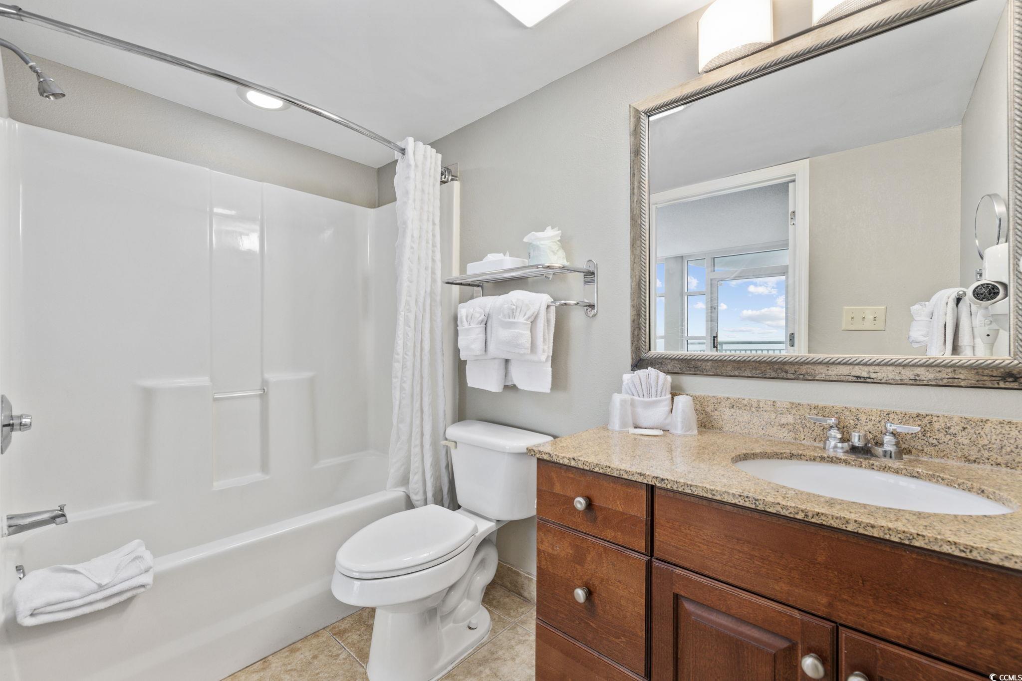 5200 North Ocean Boulevard, Unit 857 Myrtle Beach, SC 29577 - Photo 19 of 40 Full bath with shower / bath combination with curtain, vanity, and tile patterned floors