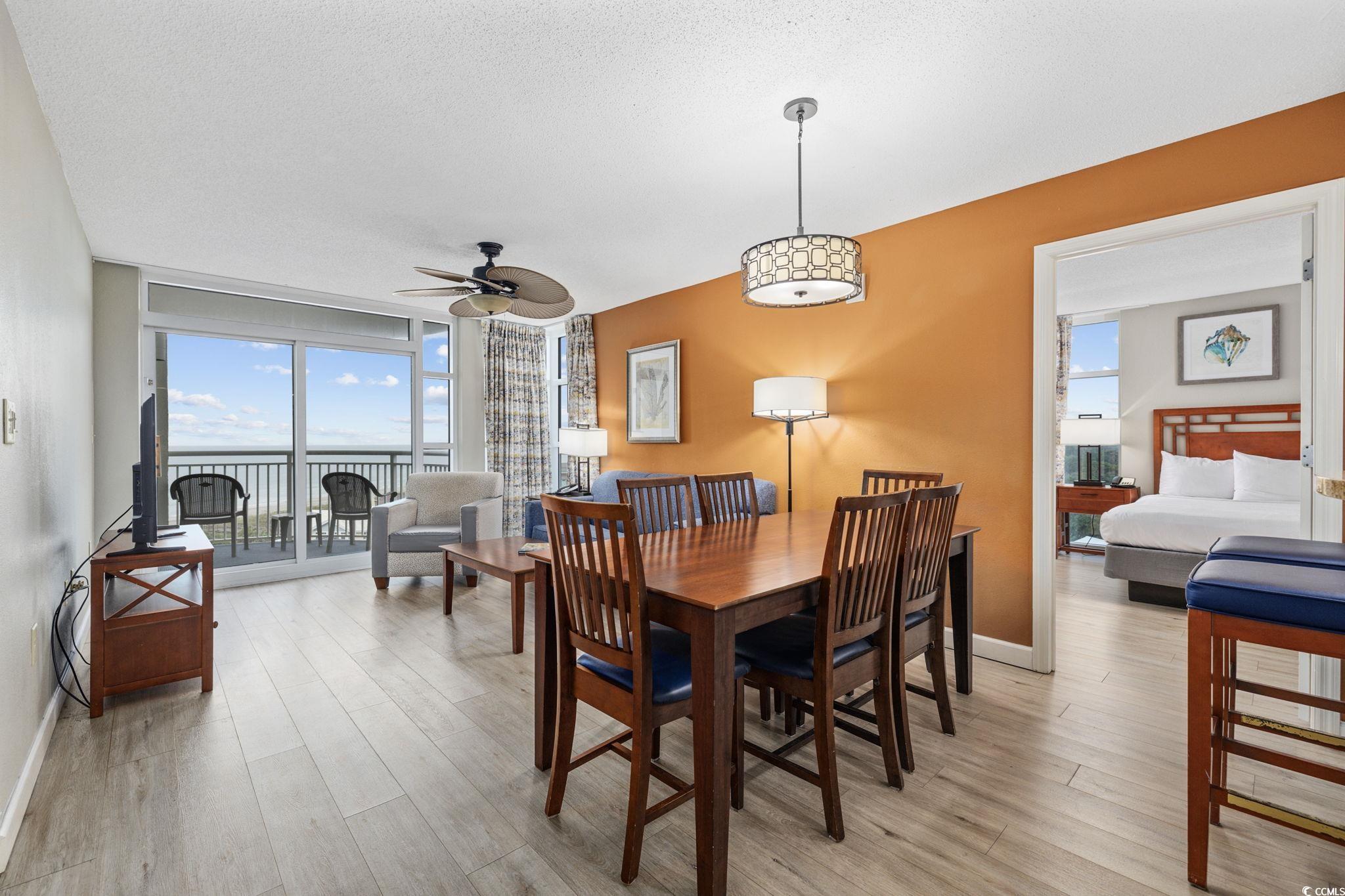 5200 North Ocean Boulevard, Unit 857 Myrtle Beach, SC 29577 - Photo 2 of 40 Dining space featuring light wood-type flooring, a textured ceiling, ceiling fan, and floor to ceiling windows
