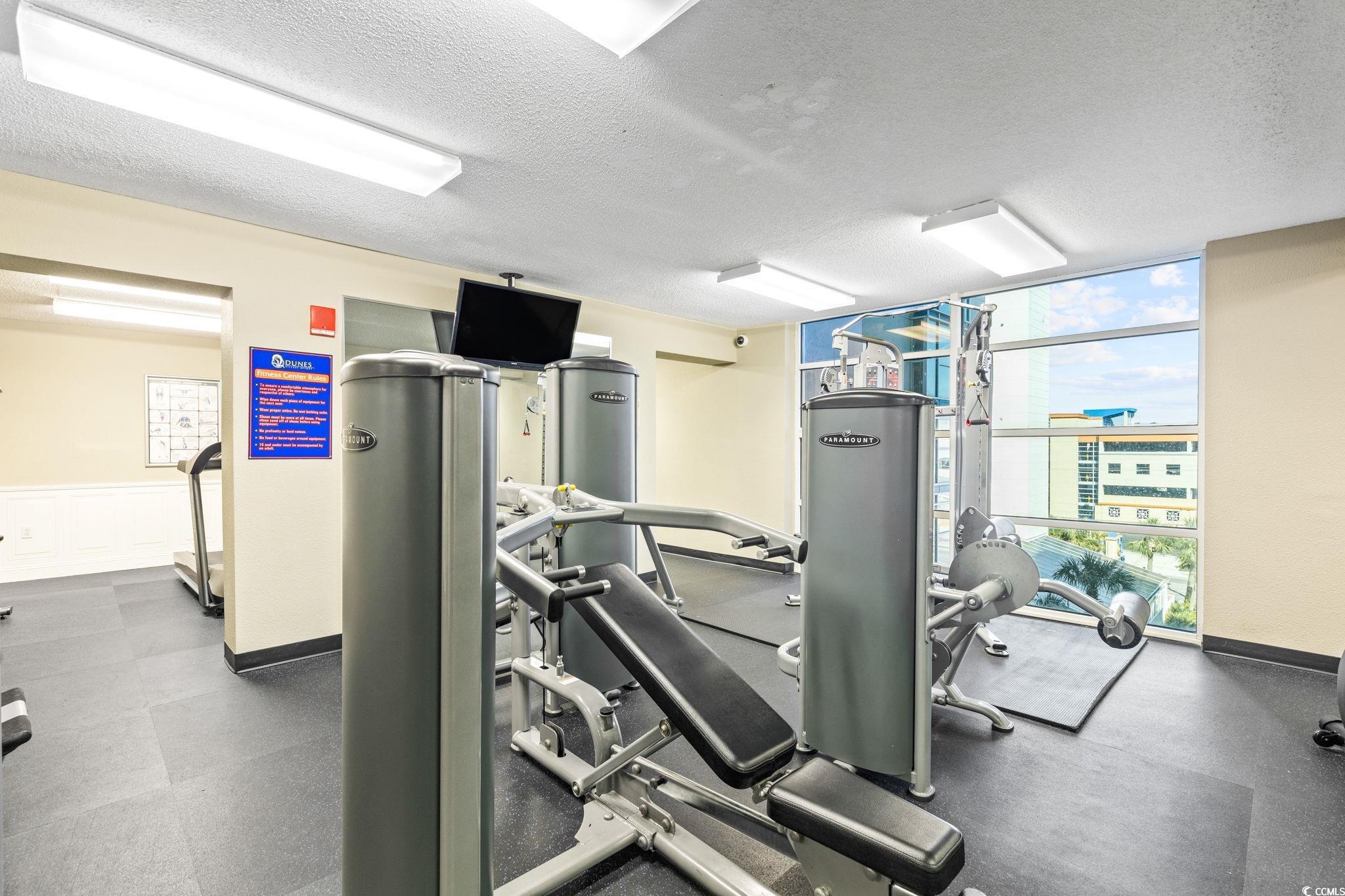 5200 North Ocean Boulevard, Unit 857 Myrtle Beach, SC 29577 - Photo 39 of 40 Exercise room with a textured ceiling and baseboards