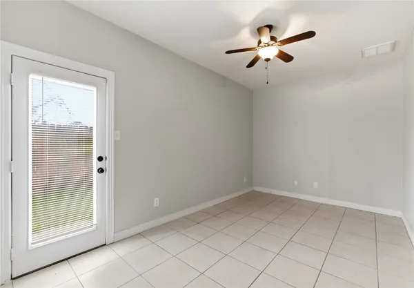a view of a small space with wooden floor and a window