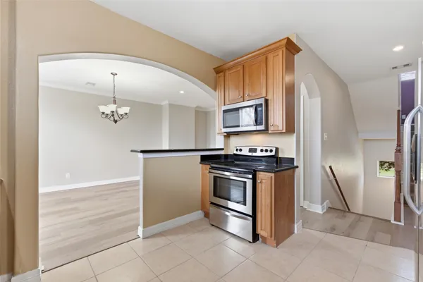 a kitchen with granite countertop a refrigerator and a sink