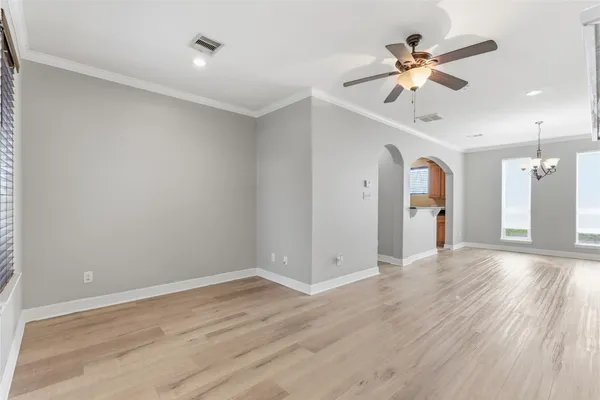 a view of a small space with wooden floor and a window