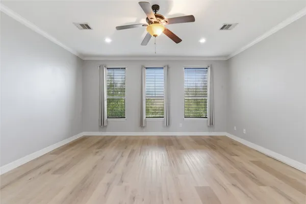 an empty room with wooden floor and entryway