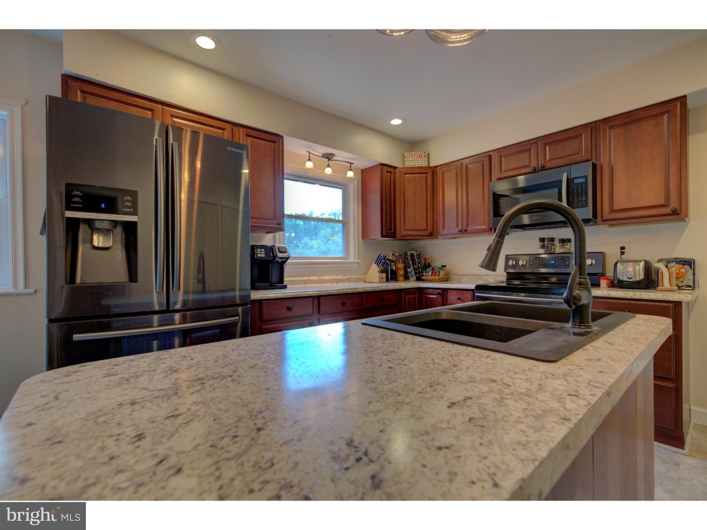 1397 Valley View Road Pottstown, PA 19465 - Photo 11 of 25 a kitchen with kitchen island granite countertop a sink stove and refrigerator
