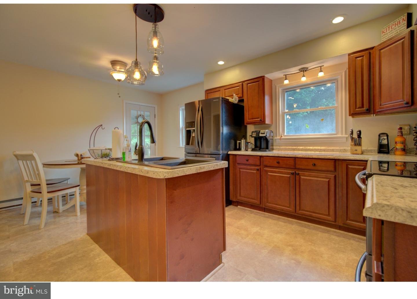 1397 Valley View Road Pottstown, PA 19465 - Photo 8 of 25 a kitchen with kitchen island granite countertop a sink cabinets and stainless steel appliances