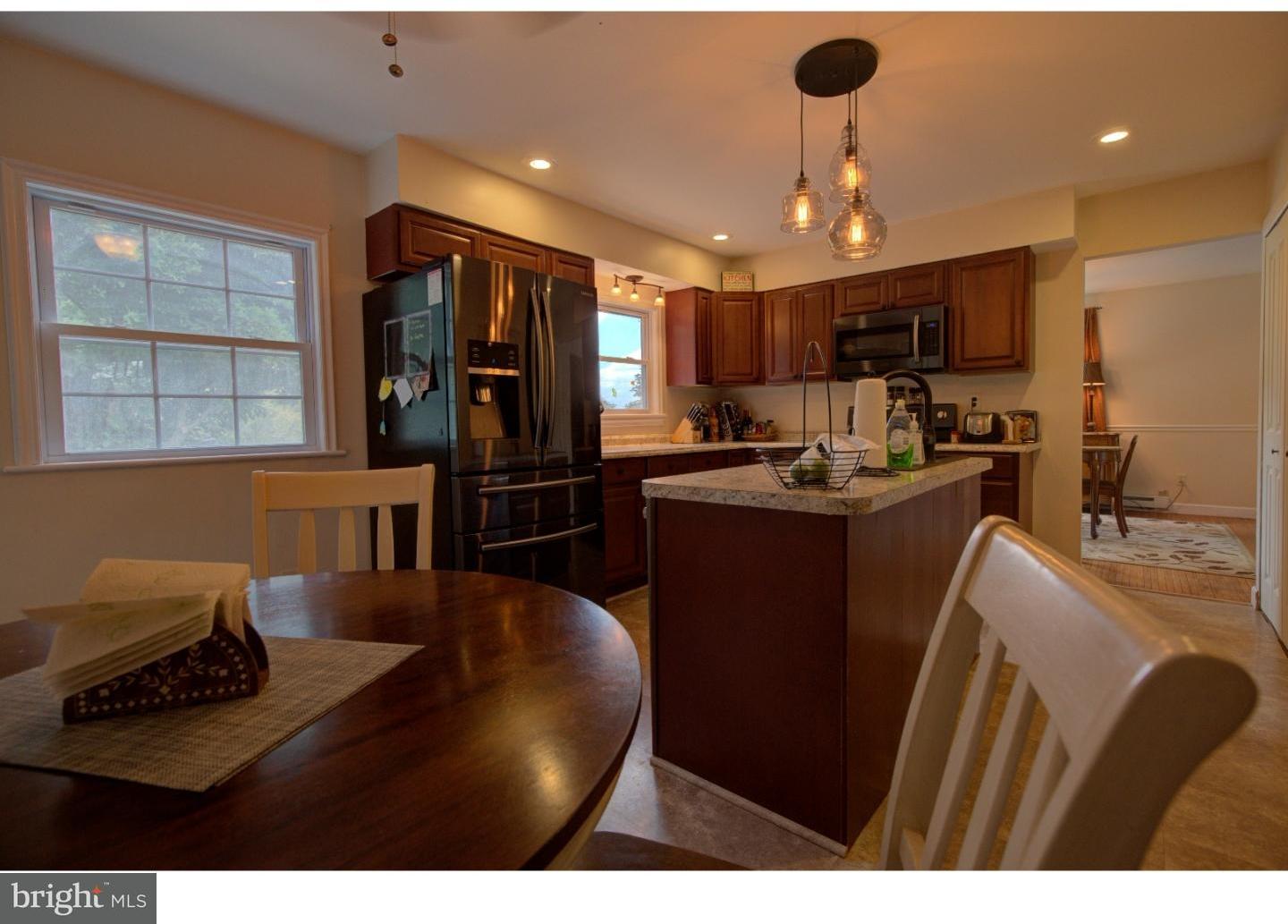 1397 Valley View Road Pottstown, PA 19465 - Photo 10 of 25 a kitchen with stainless steel appliances kitchen island granite countertop a refrigerator a stove top oven and a sink with wooden floor