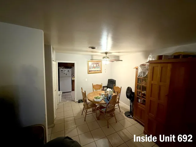 a kitchen with a refrigerator and a stove top oven