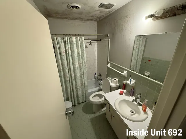 a bathroom with a toilet and shower