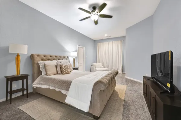 a bedroom with bed and flat tv