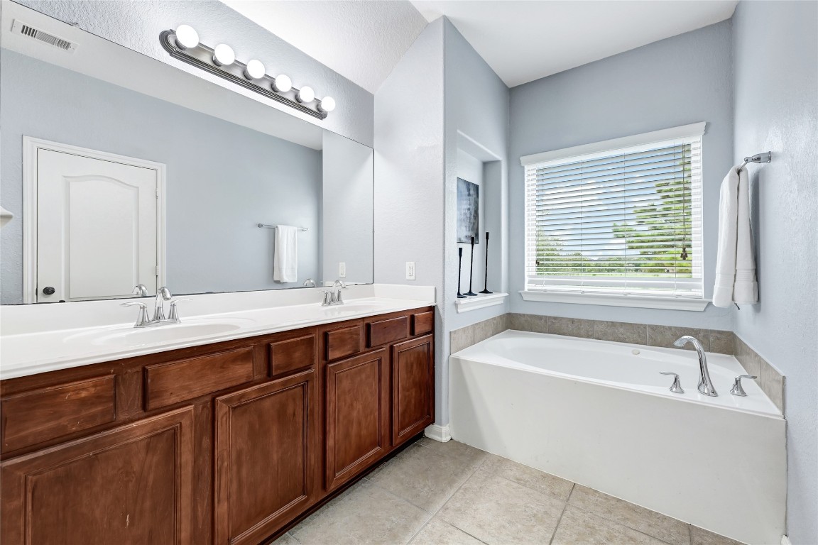 1501 Kent Valley Lane Rosenberg, TX 77471 - Photo 17 of 27 a bathroom with a tub a sink and a window