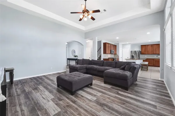 a living room with furniture and a wooden floor