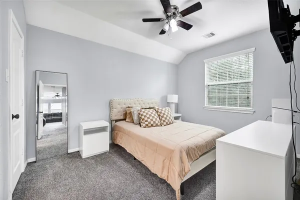 a bedroom with a bed and window