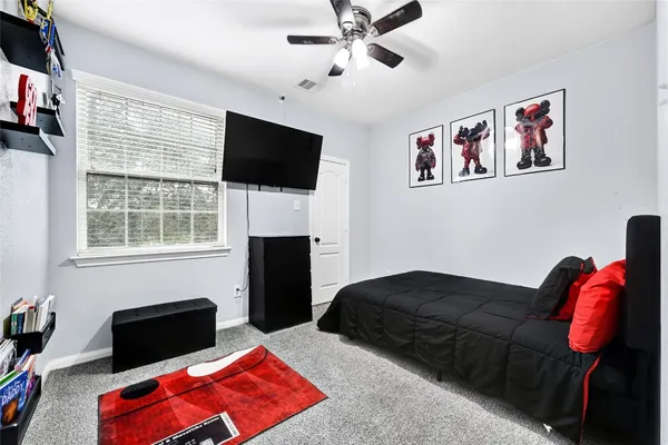 a living room with furniture a flat screen tv and a window
