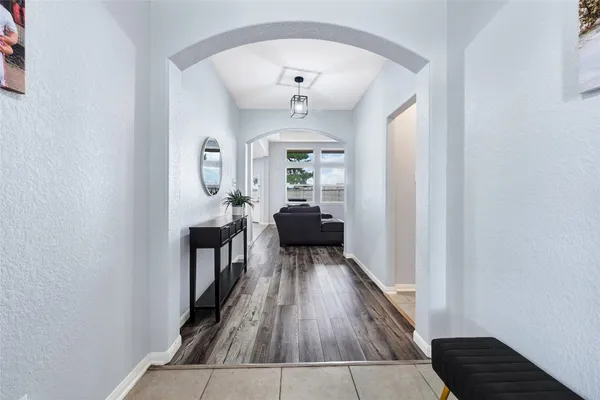 a view of a hallway view with wooden floor and staircase