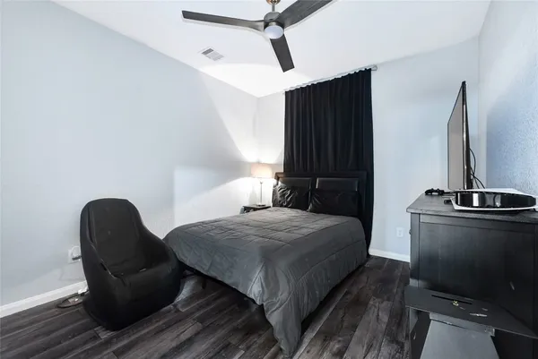 a bedroom with a bed and a chair