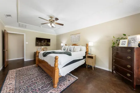 a bed room with a bed and a ceiling fan