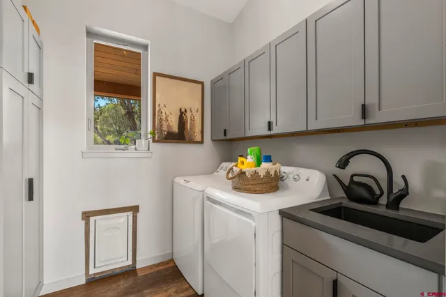a kitchen with a sink a stove and cabinets