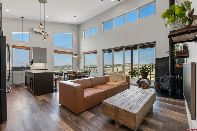 a living room with furniture kitchen and a table