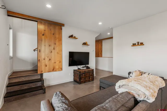 a bedroom with a bed and flat screen tv