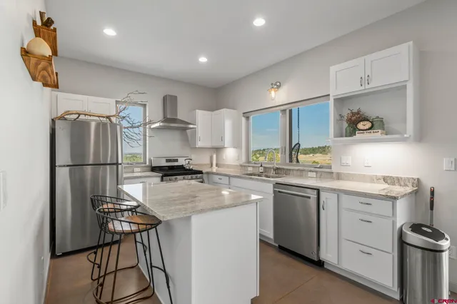 a kitchen with a sink stainless steel appliances and cabinets