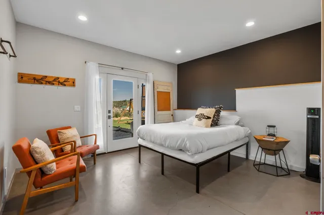 a spacious bedroom with a bed and a couch