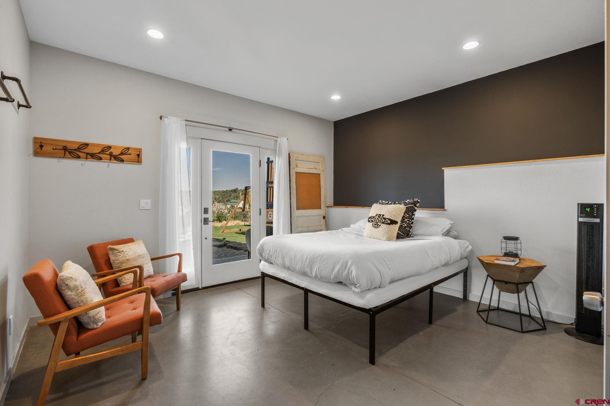 68 Cody Road Durango, CO 81303 - Photo 29 of 45 a spacious bedroom with a bed and a couch