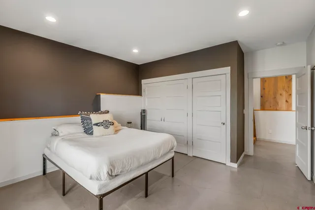 a bedroom with a bed and a table